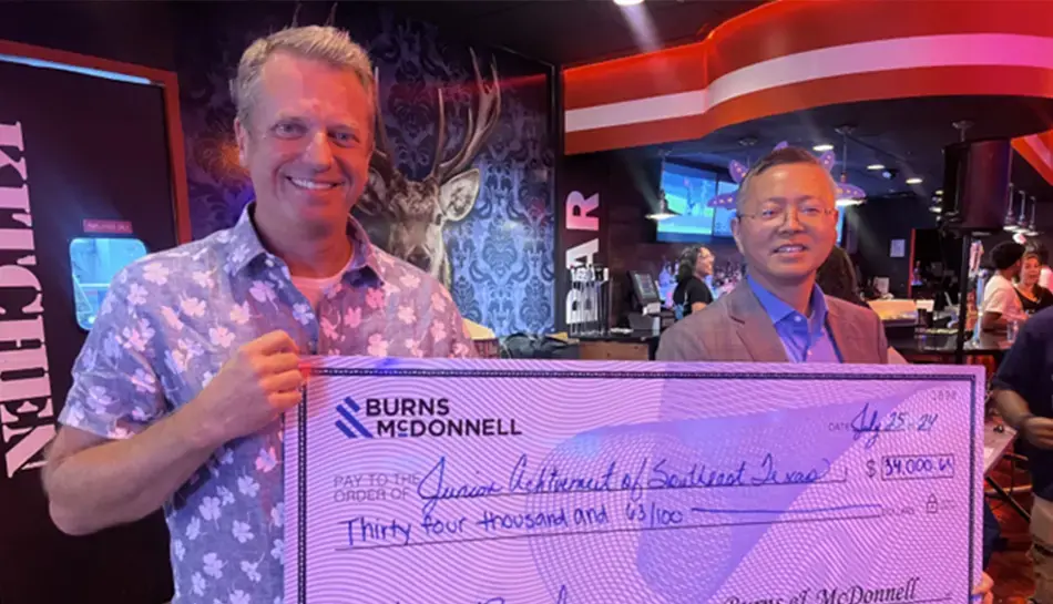 giant check donation at Junior Achievement event