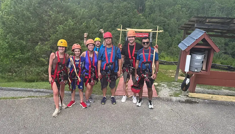 team members dressed for ziplining event