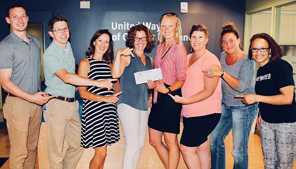 Team members highlighting funds raised