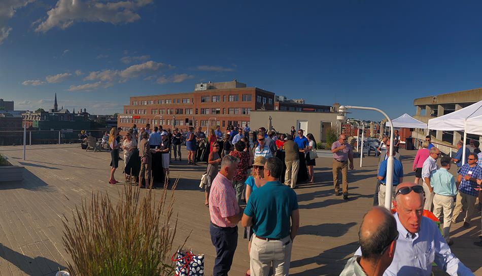 Employees gather for a rooftop event