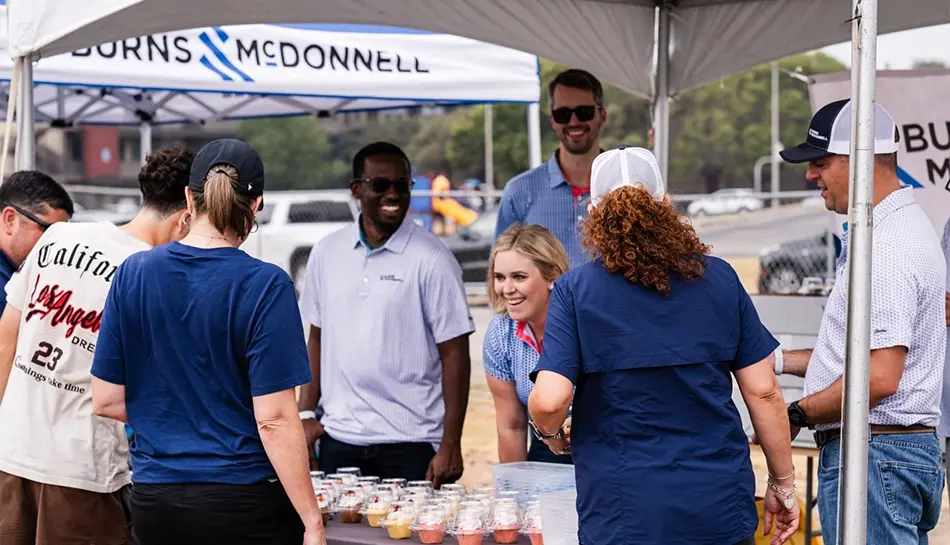 people interact at an event booth