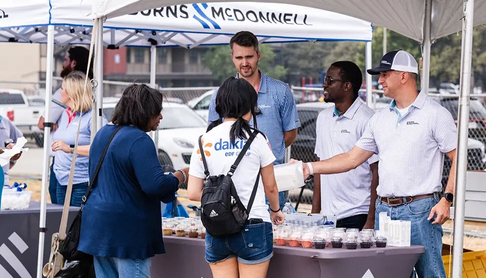 people interact at an event booth