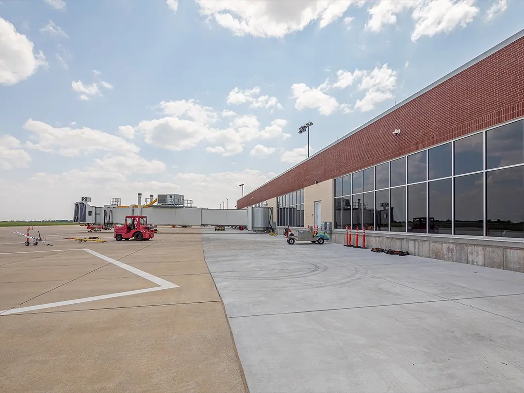 airside exterior with boarding bridge and ground support equipment