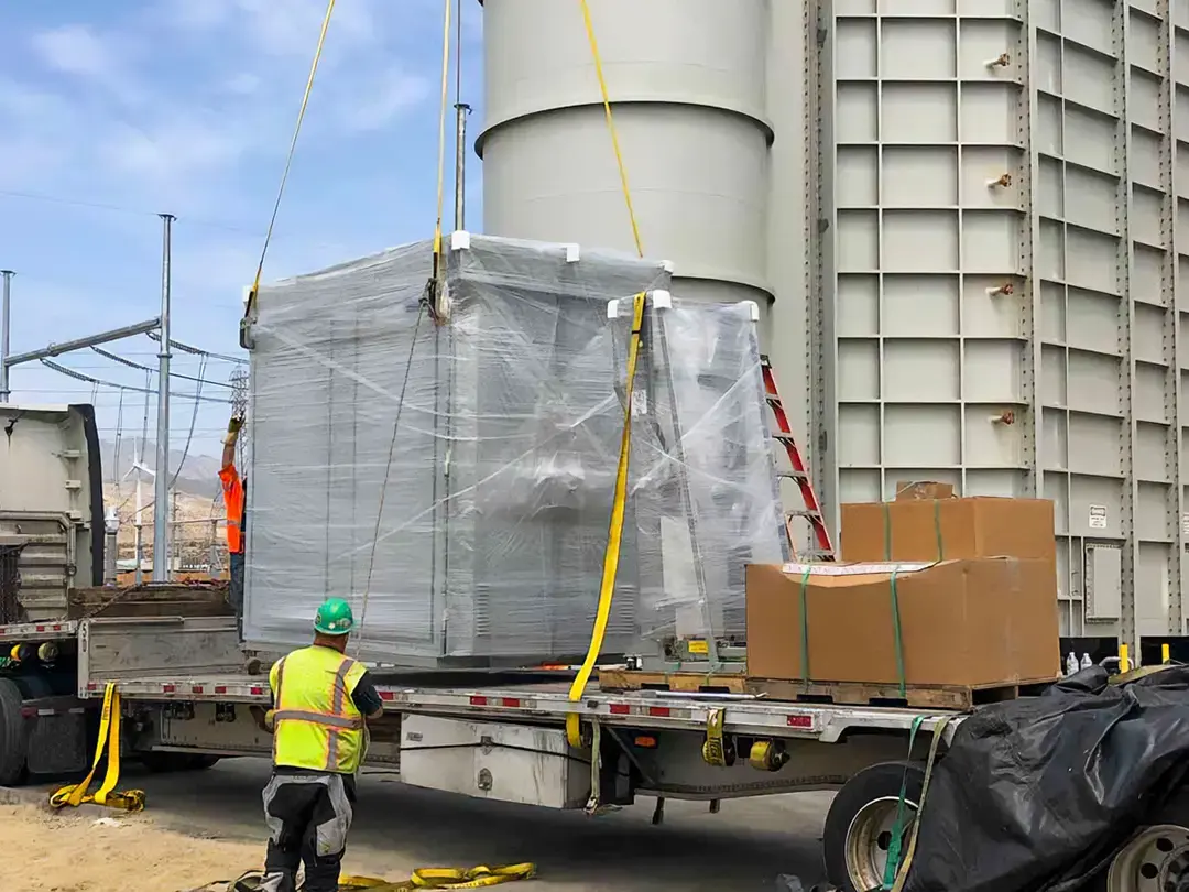 equipment arrival on truck, being moved via crane