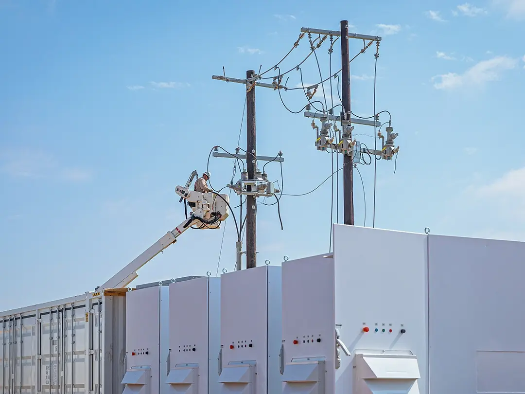overhead pole work from bucket lift next to battery units