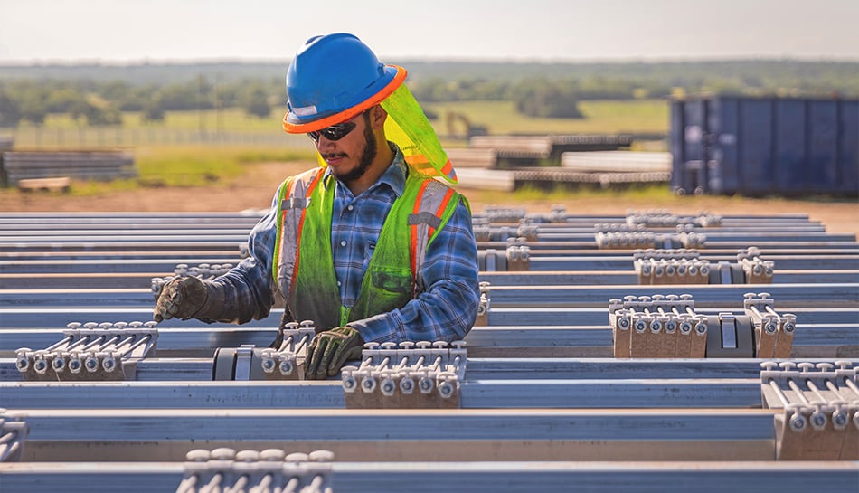 construction worker assembles solar array