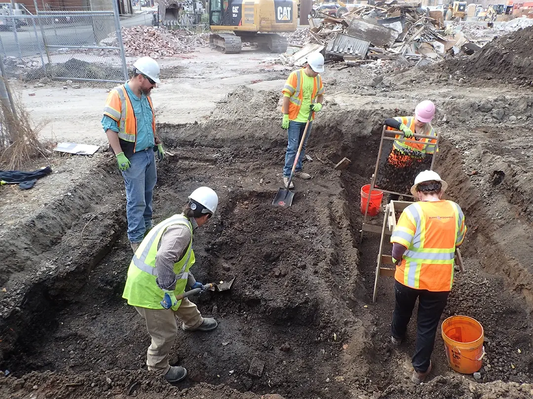 workers excavate historical objects at project site
