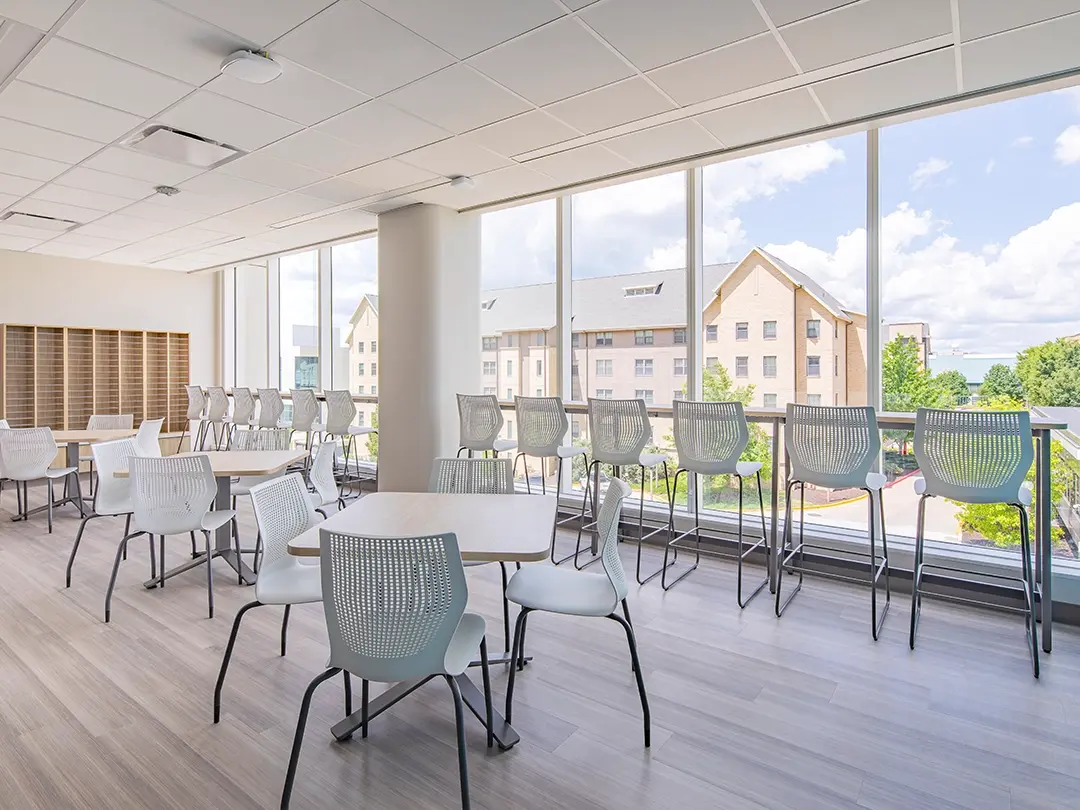 hospital break area with tables and bar seating at window