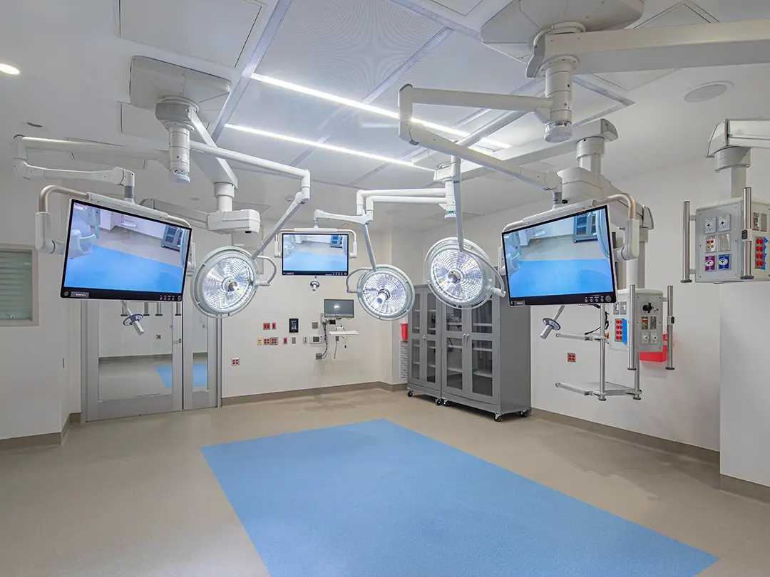 hospital procedure room with lighting and camera screens, equipment