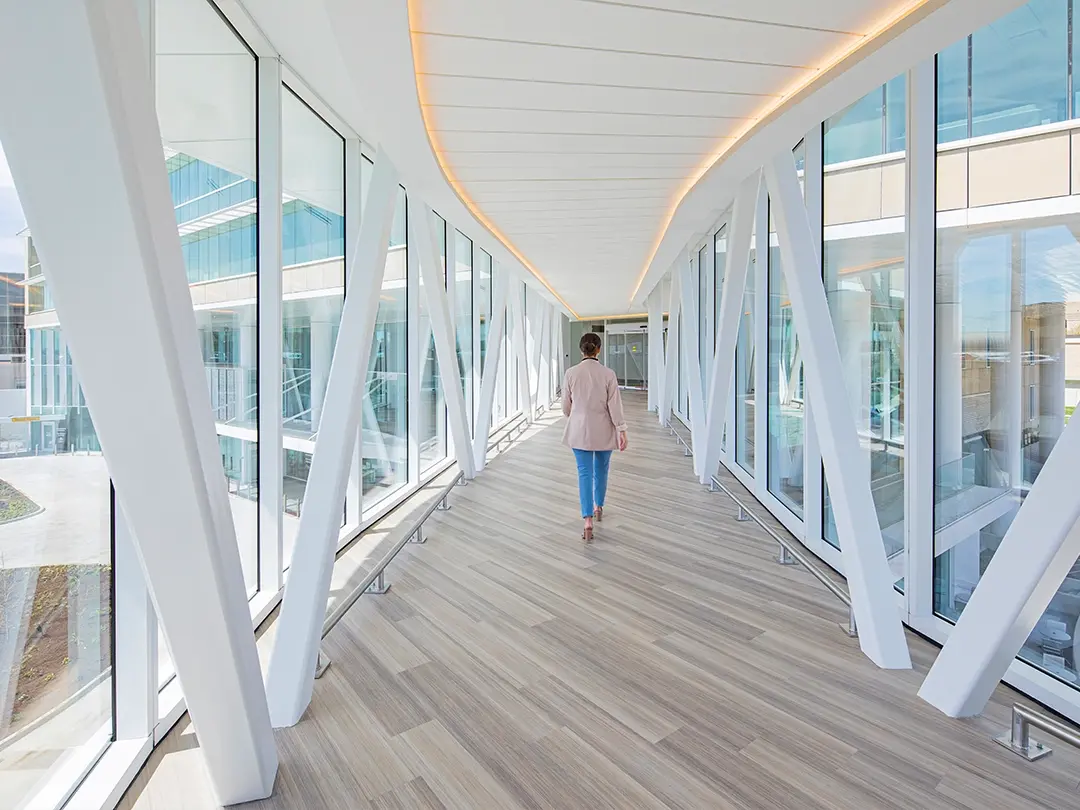 interior of elevated walkway between buildings with a woman walking