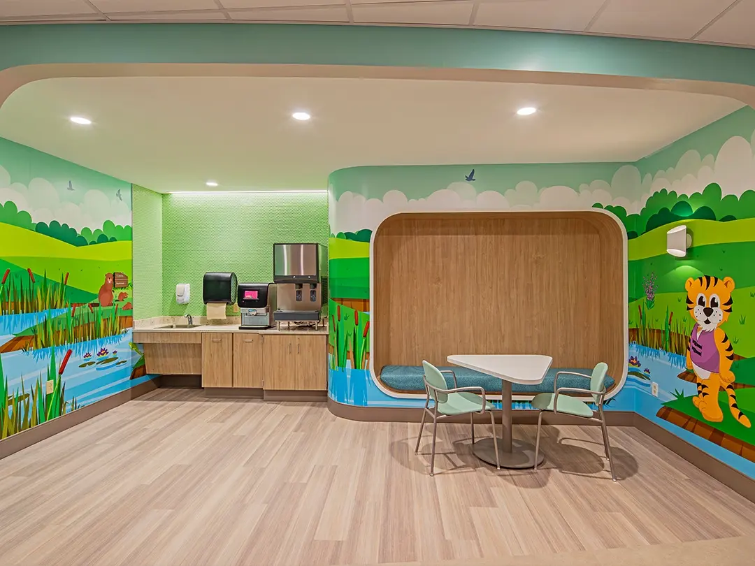 break station with sink, drink station, cubby seating, table, chairs and colorful cartoon nature murals