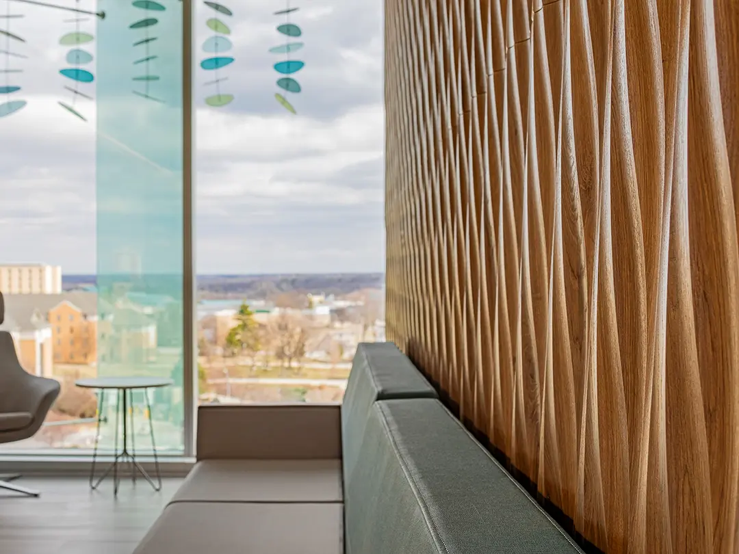close-up view of carved wood wall treatment with visitor lounge of hospital
