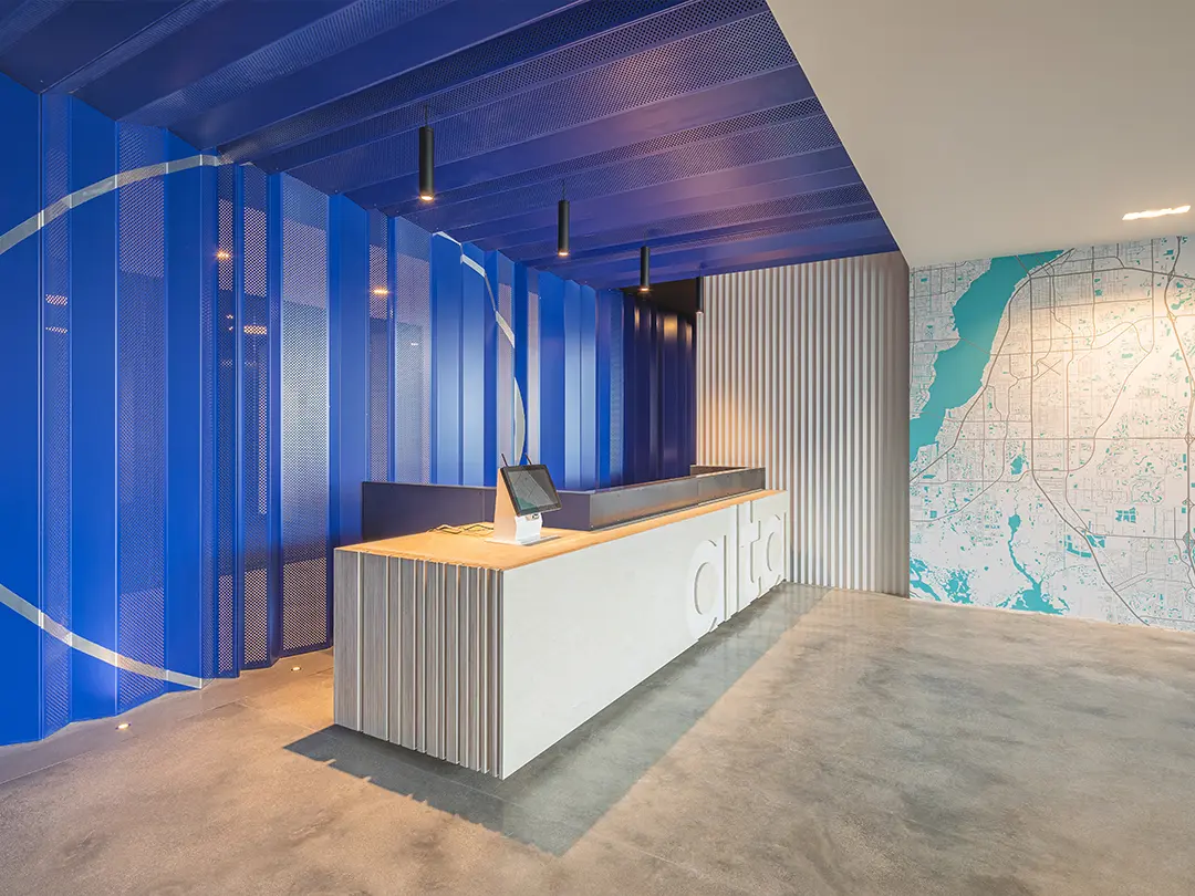 lobby area with reception desk, map and decorative folding wall