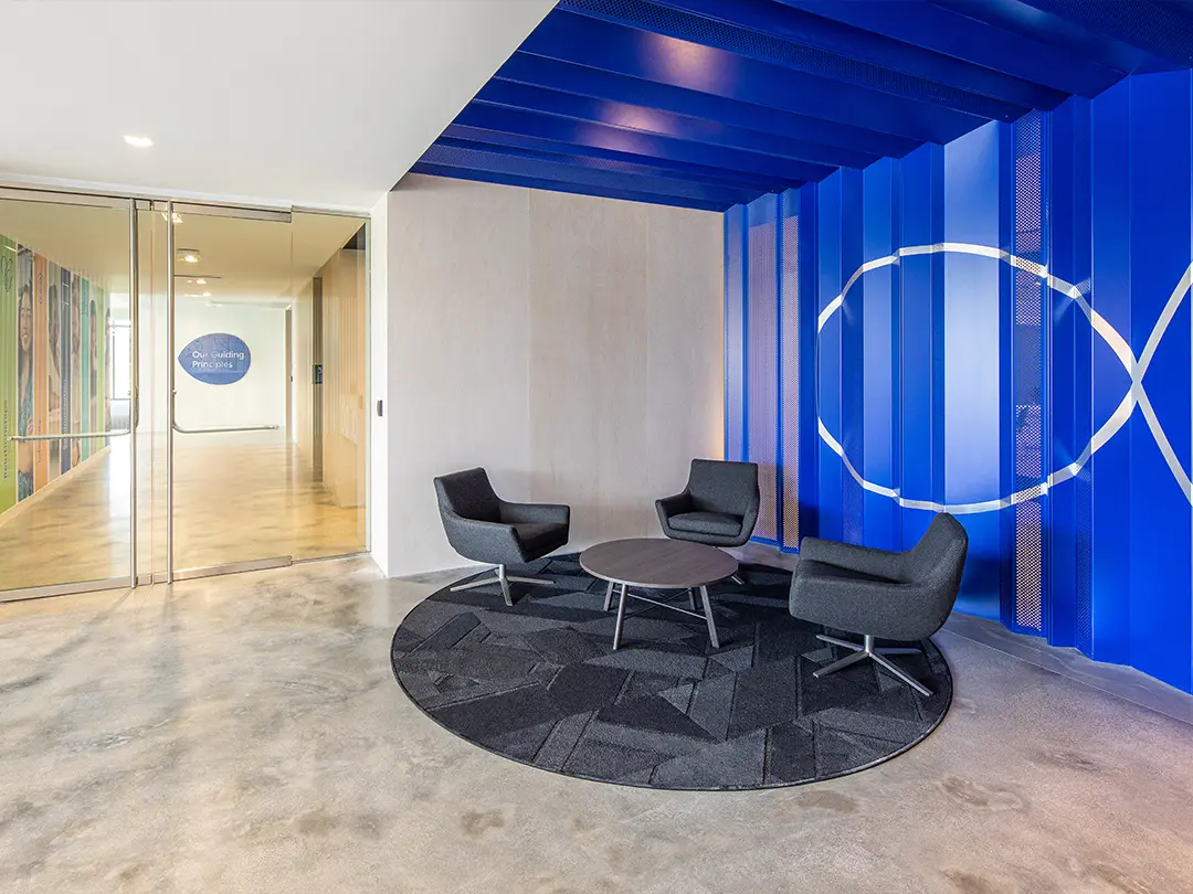 seating area next to folding decorative wall and controlled-access glass doorway to hallway