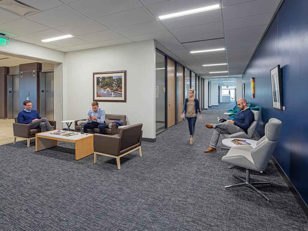 people in waiting area of corporate office setting