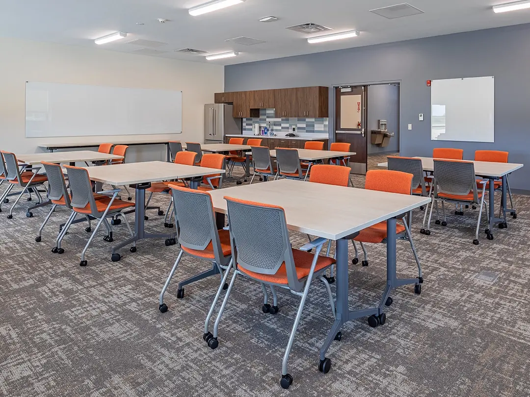 break room with tables and kitchenette