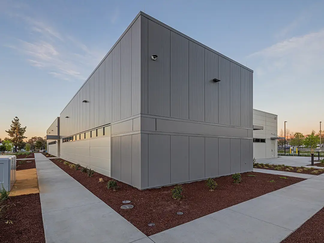 exterior of building with sidewalk and plantings