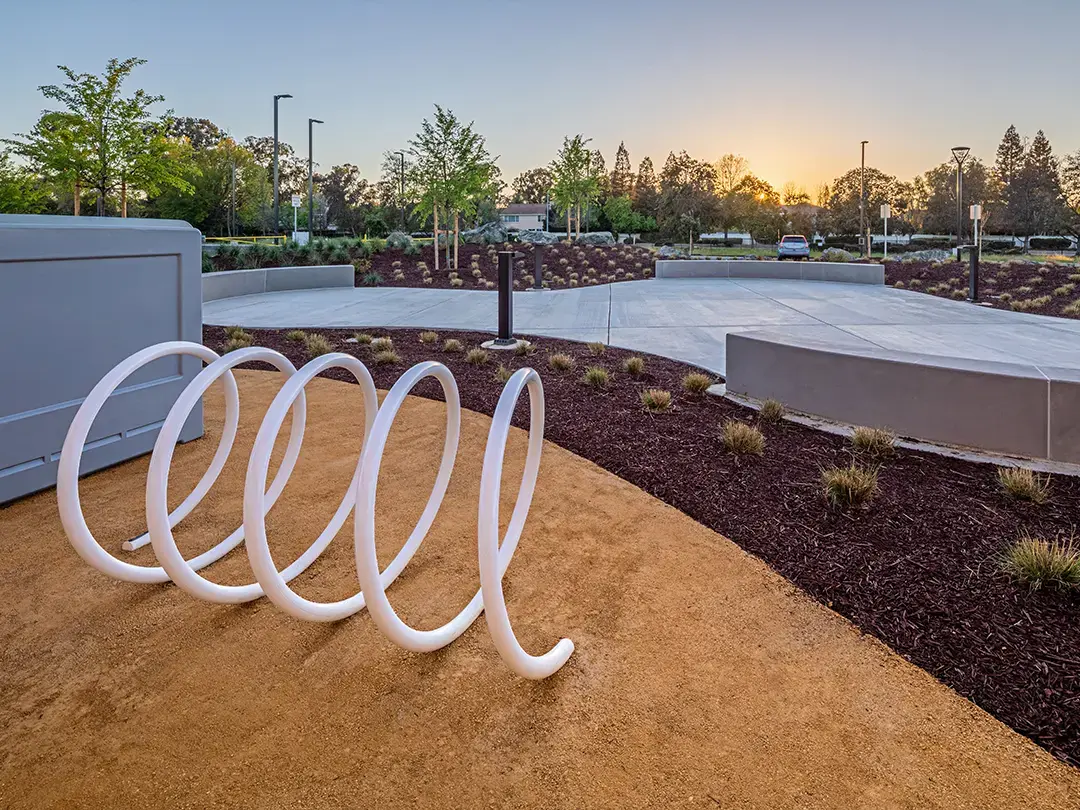 plaza space in front of building with bike rack and landscaping