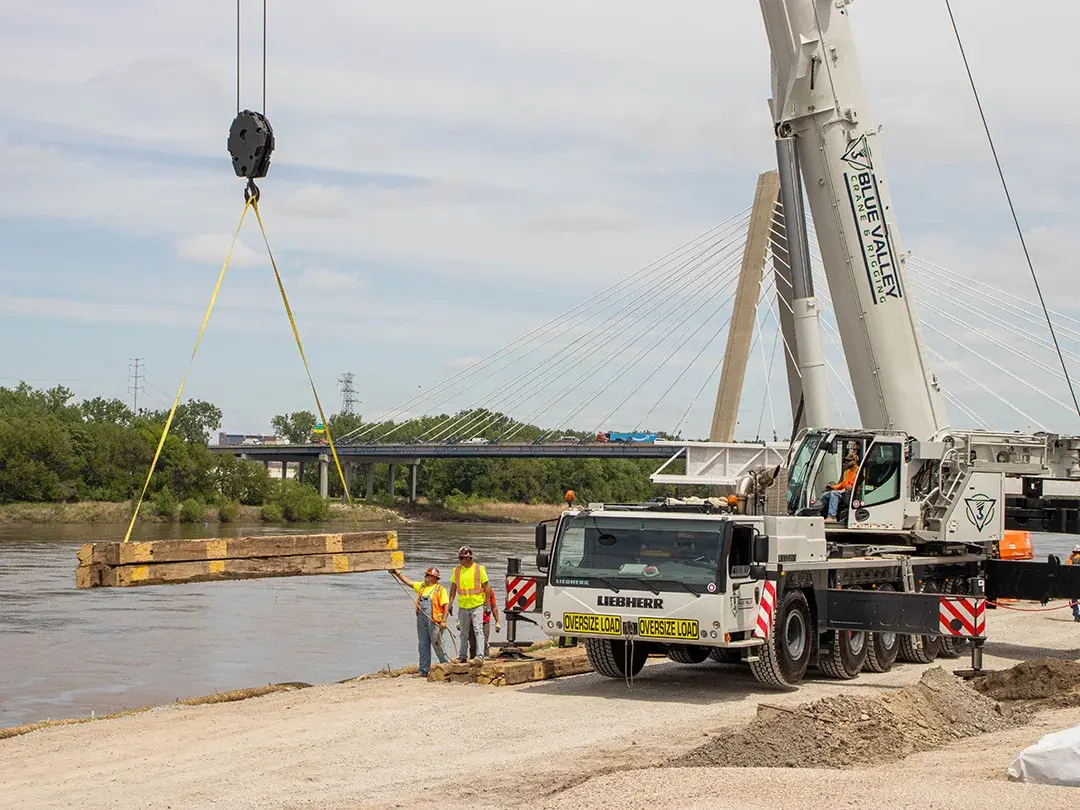 construction crane moving materials into place on job site