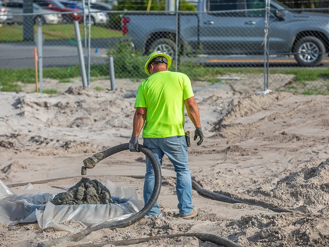 construction worker pouring concrete