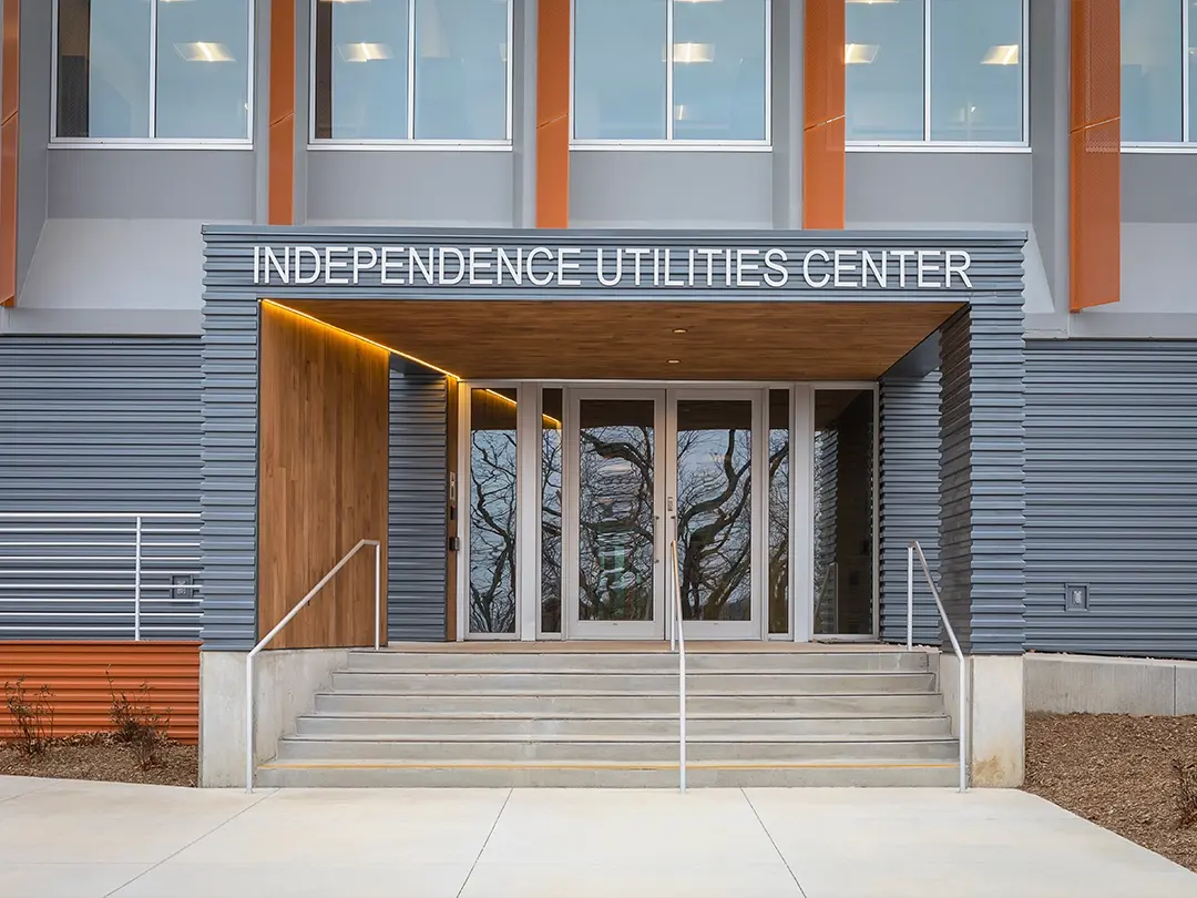 building entrance steps and ramp with overhead sign