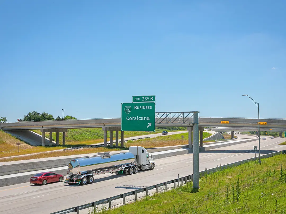 traffic on widened interstate highway at exit ramp