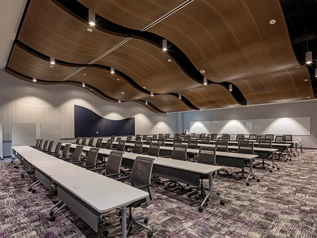 large training room with classroom-style seating and dramatic ceiling treatment