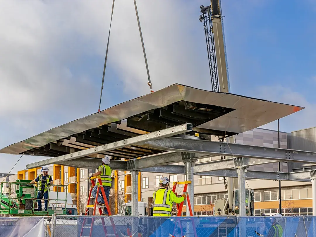 pavilion roof being set in place via crane