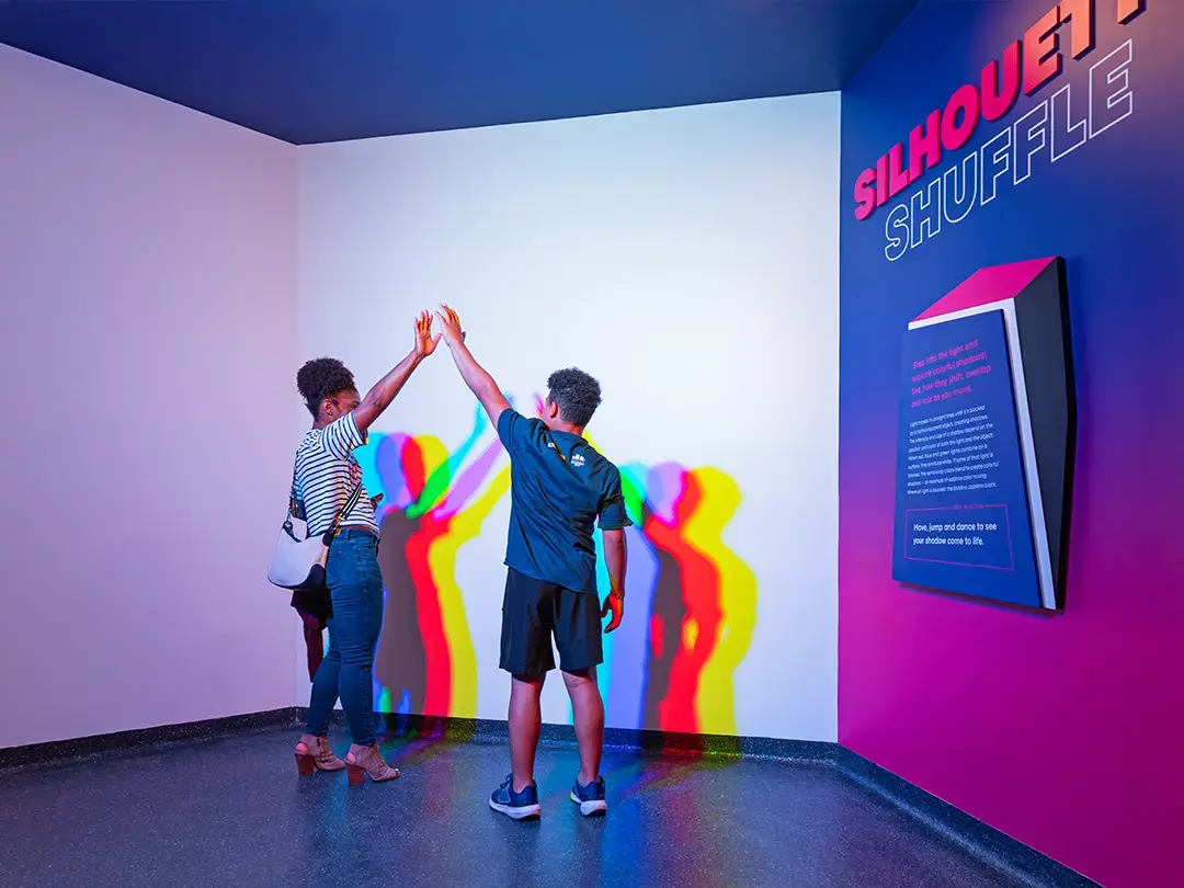 visitors experiment with color shadow exhibit