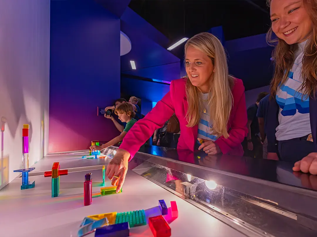 visitors try out an exhibit