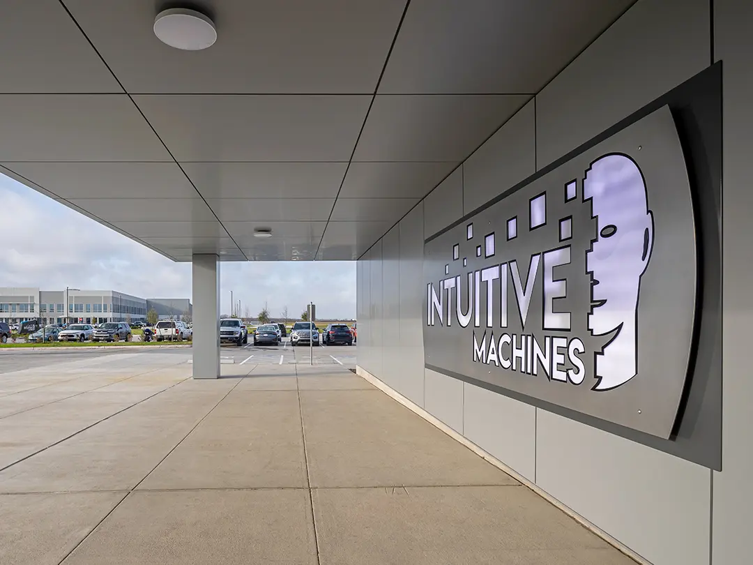 building entry covered walkway with corporate logo sign