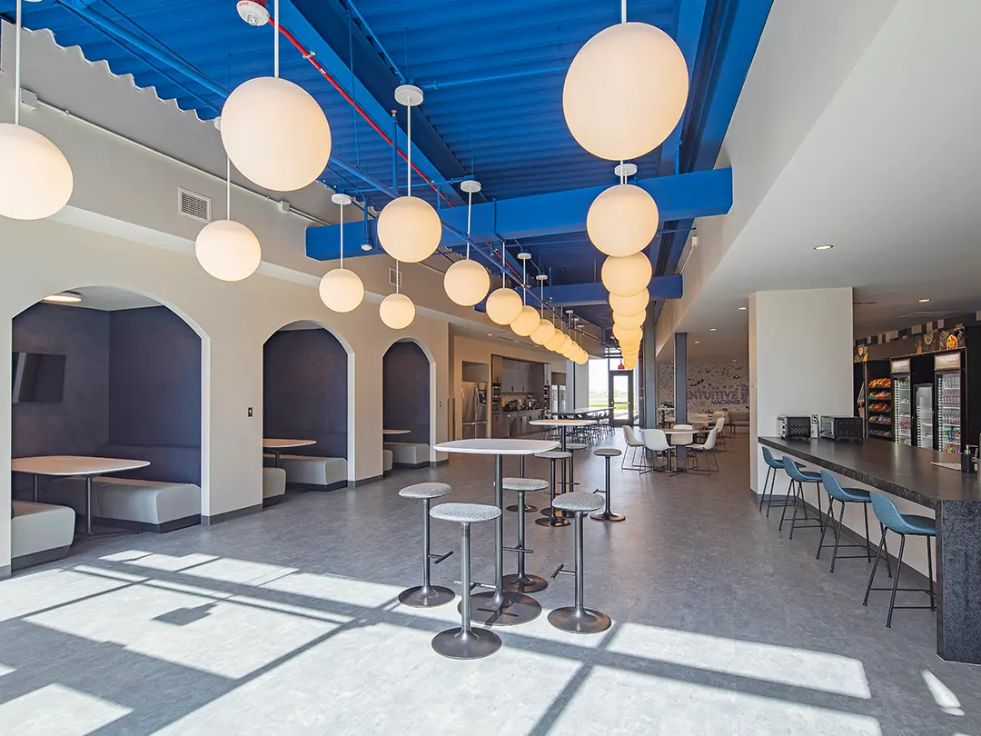 employee break area with vending, kitchen, high-top seating and booth alcoves