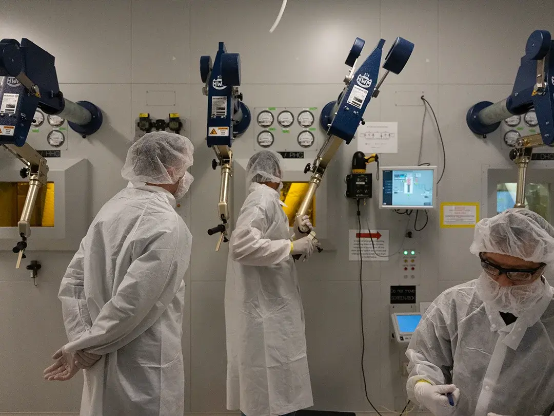 several staff members working and observing use of equipment
