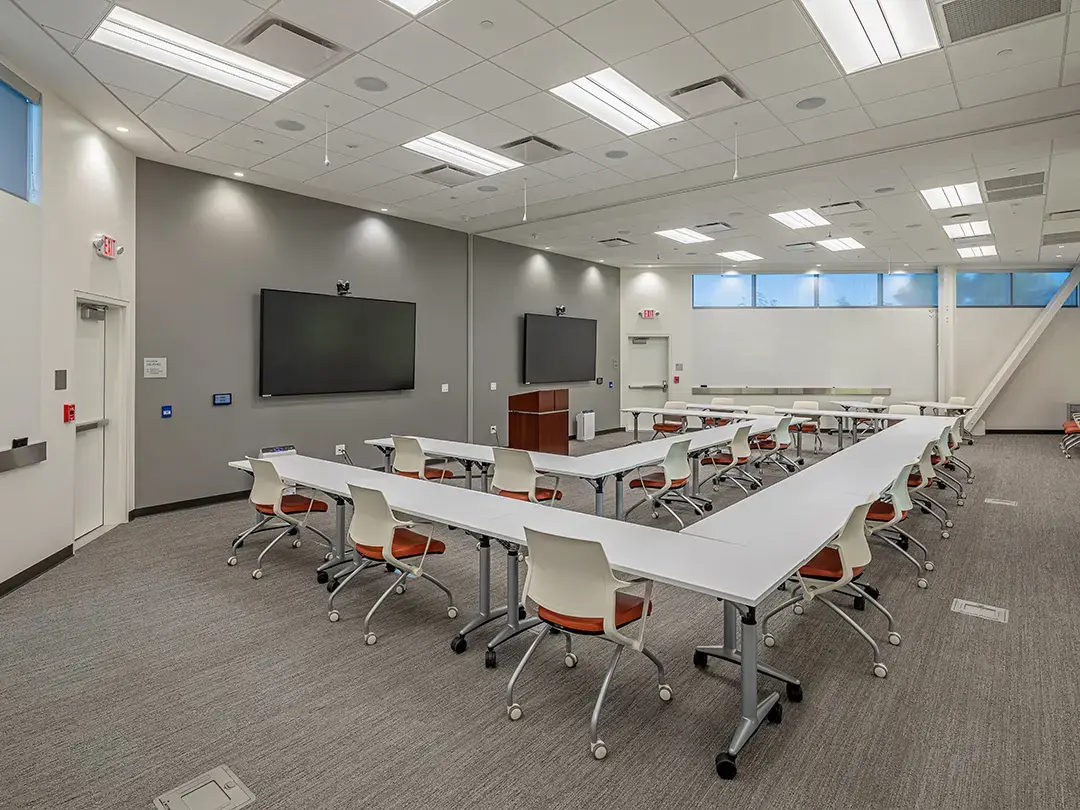 conference room with double U table arrangement and LCD screens
