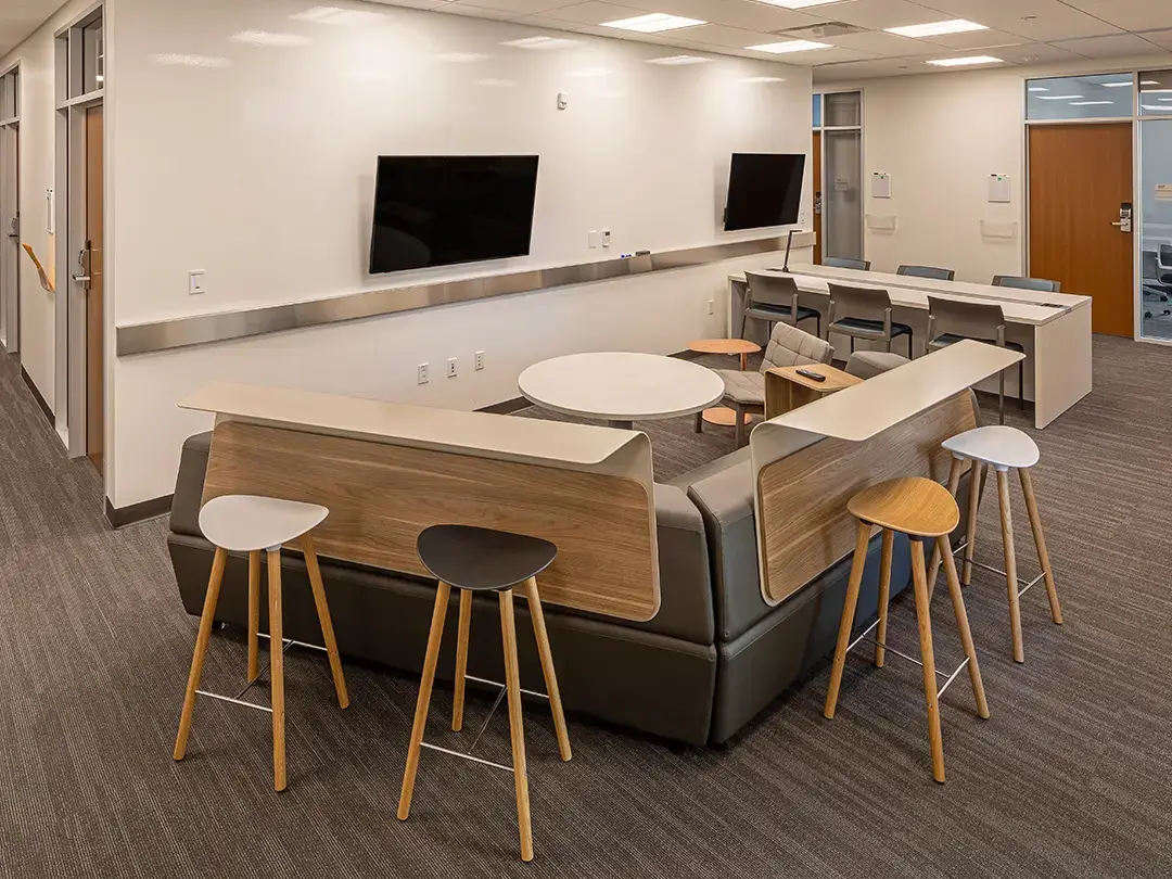 casual meeting space with LCD screens, bar seating and conference table