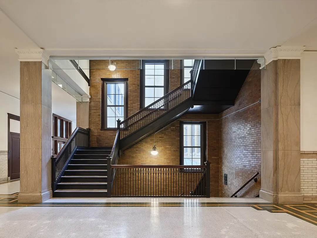 historic school building stairway preserved, with mosaic tile flooring