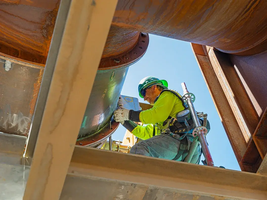construction workers on elevated platform viewed from below