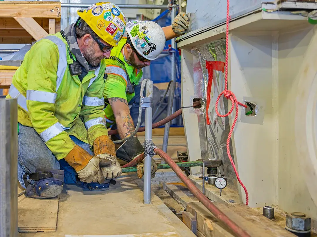 construction workers installing piping