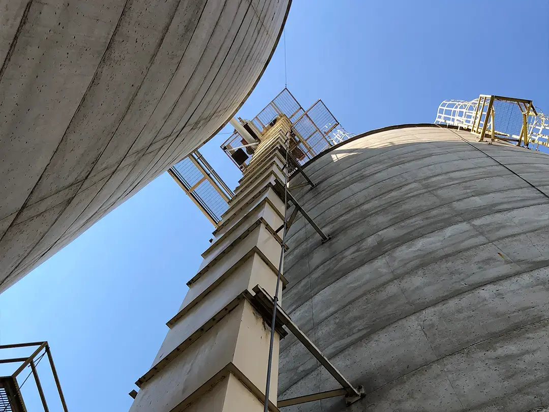 looking up from ground to top of storage silos