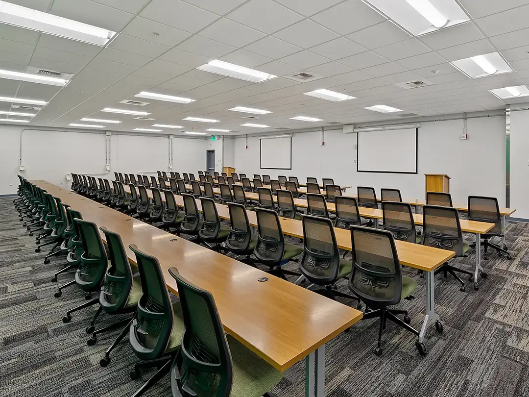 large conference room set up with classroom-style tables and chairs