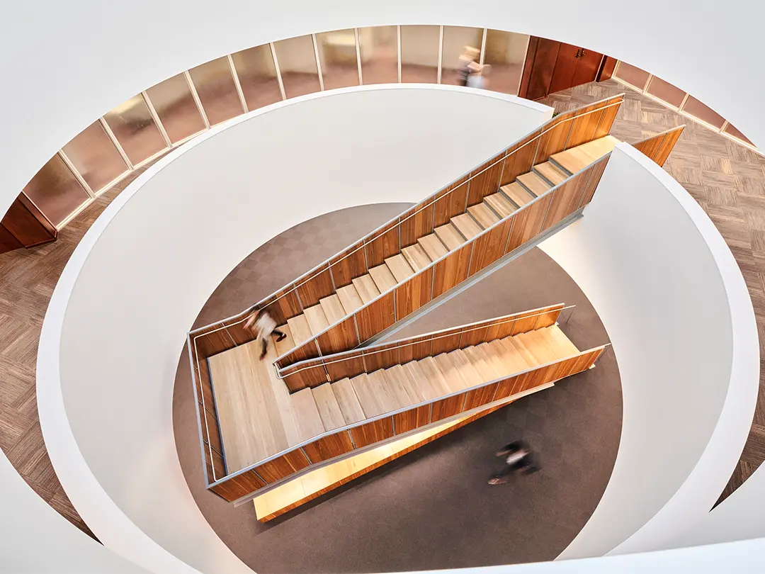 view from above looking down at dramatic wood-clad staircase