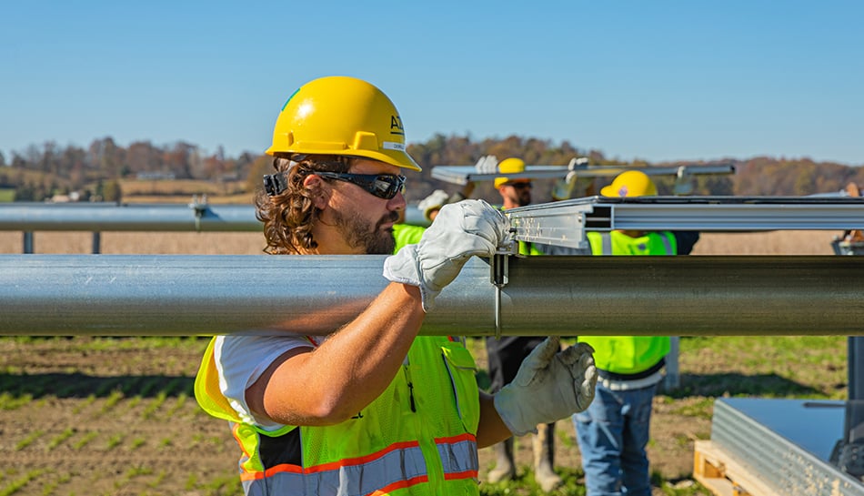 construction workers install solar panel infrastructure