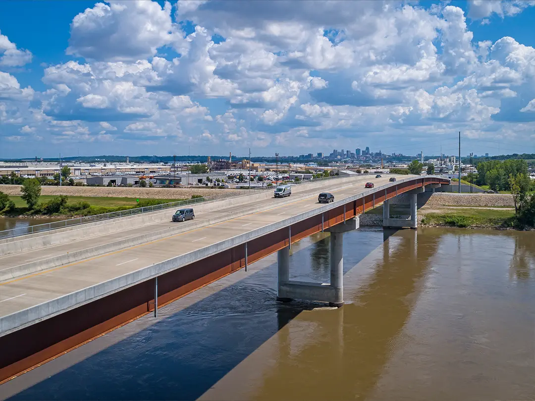 cars crossing bridge over river