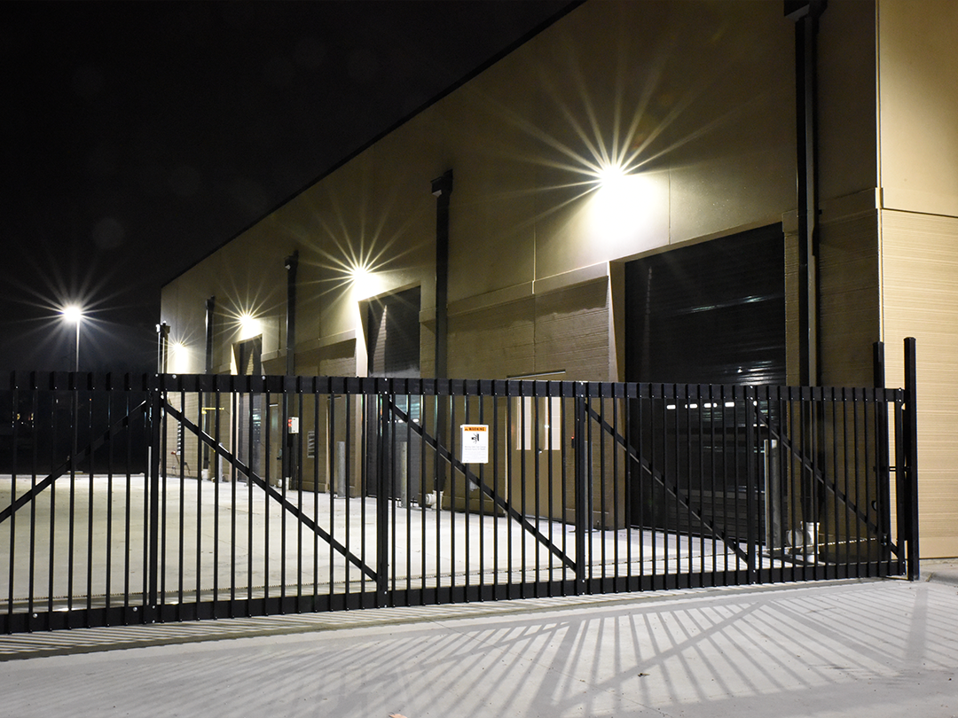 building exterior at night with security fence
