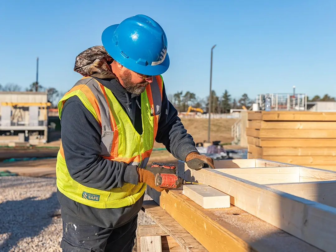construction worker builds framing components