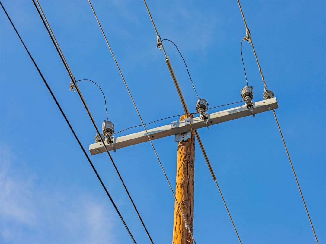 lines crossing a distribution pole